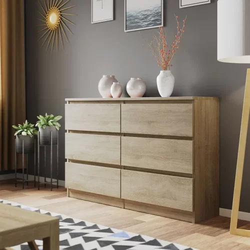 Aprovecha la oferta de nuestra cómoda de 6 amplios cajones, fabricada en melamina de 18 mm y diseñada en un elegante color roble. Esta cómoda no solo transforma cualquier espacio con su apariencia minimalista y sofisticada, sino que también ofrece una solución de almacenamiento práctica y duradera. Elegancia Minimalista Con su diseño sin tiradores, esta cómoda presenta una estética limpia y contemporánea que se integra perfectamente en cualquier ambiente. El color roble aporta luminosidad y sensación de amplitud, ideal para crear un entorno relajante y acogedor.