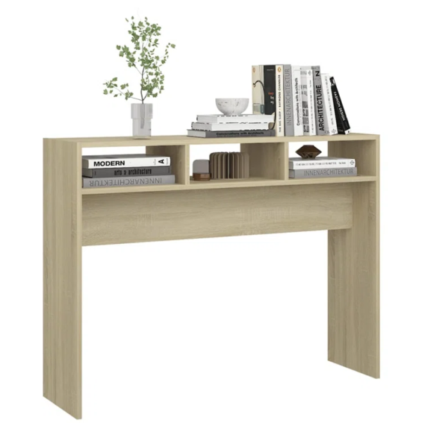 Aprovecha la oferta de nuestra mesa consola en color roble es el mueble ideal para quienes buscan un equilibrio perfecto entre diseño moderno y funcionalidad. Su amplio espacio en la superficie, junto con las 3 divisiones superiores, proporciona una solución de almacenamiento práctica sin sacrificar estilo. Este mueble, fabricado con melamina de alta calidad de 18 mm, es resistente, duradero y fácil de mantener, lo que lo convierte en una excelente opción para cualquier hogar.