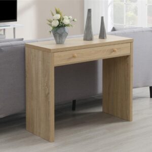 Aprovecha la oferta de La mesa consola en color roble con un amplio cajón y tiradores de madera es la elección perfecta para quienes buscan un mueble que combine diseño, funcionalidad y calidad. Sus medidas de 76 cm de alto, 91 cm de ancho y 40 cm de profundidad la hacen ideal para adaptarse a cualquier espacio, desde la entrada de tu hogar hasta la sala de estar o el dormitorio.